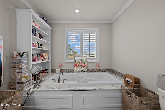 bathroom with ornamental molding and a tub