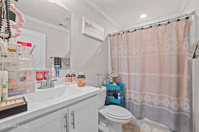 bathroom featuring crown molding, vanity, wood-type flooring, and toilet