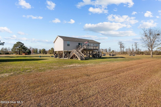 back of property with a lawn and a wooden deck