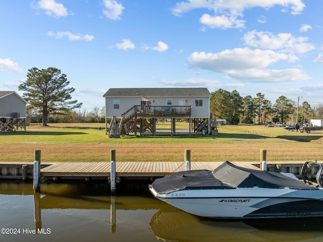 view of dock with a lawn and a deck with water view