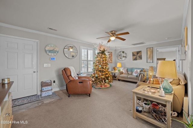 carpeted living room featuring ceiling fan and ornamental molding