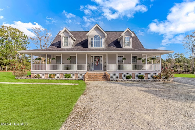 farmhouse inspired home featuring covered porch and a front lawn