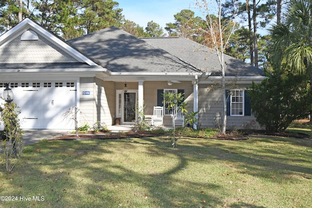 view of front of property with covered porch, a front yard, and a garage