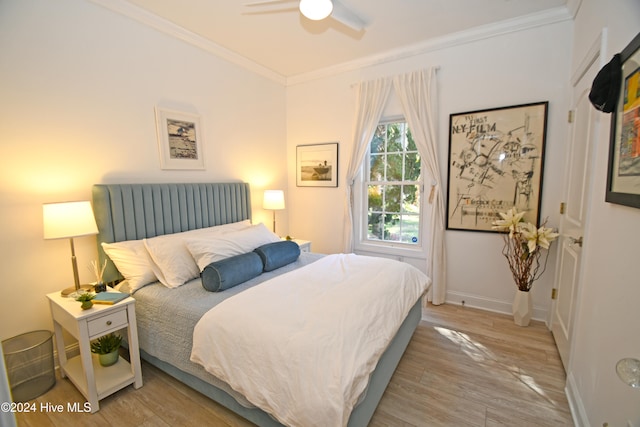 bedroom with ceiling fan, light wood-type flooring, and crown molding