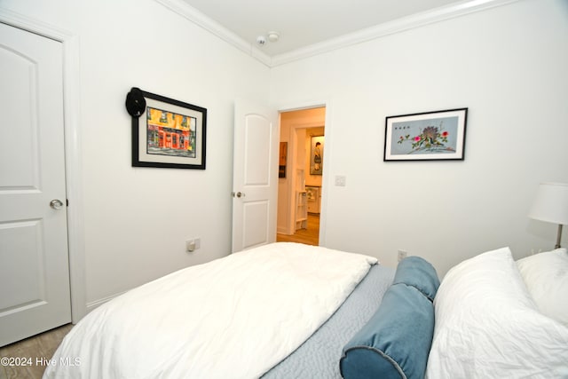 bedroom featuring hardwood / wood-style flooring and ornamental molding