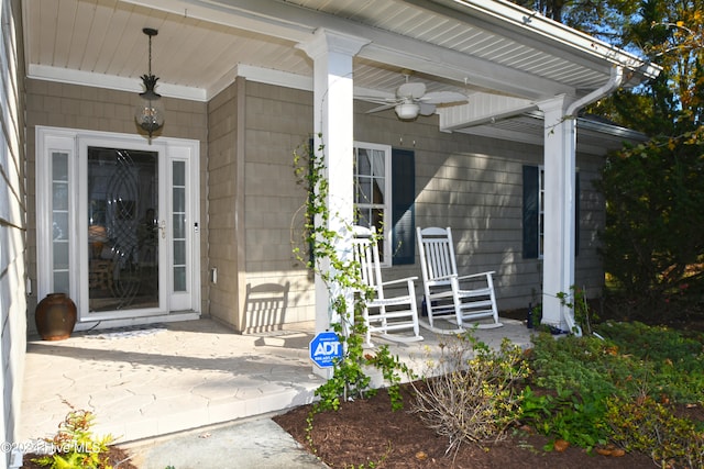 entrance to property with ceiling fan and covered porch