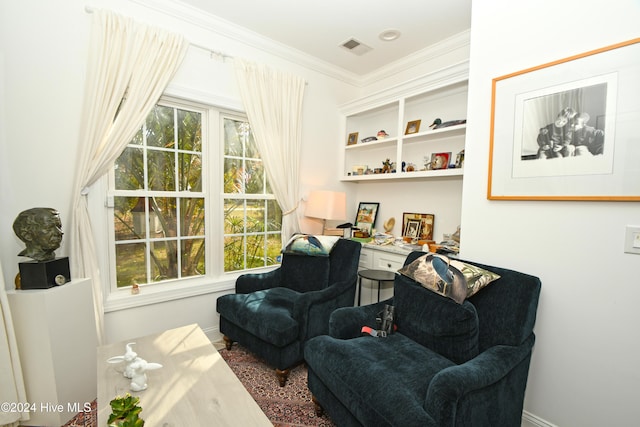 living area featuring ornamental molding