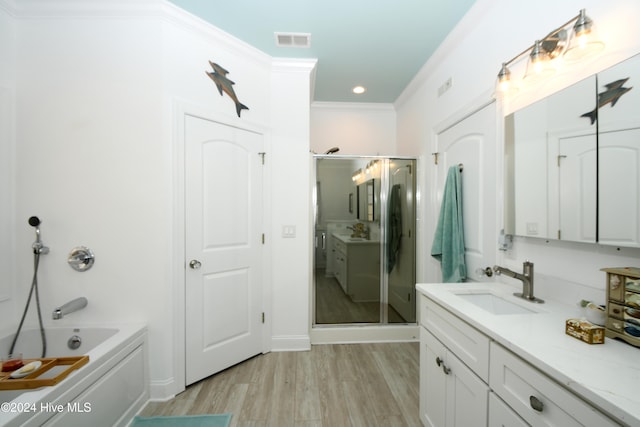 bathroom with hardwood / wood-style floors, vanity, separate shower and tub, and crown molding