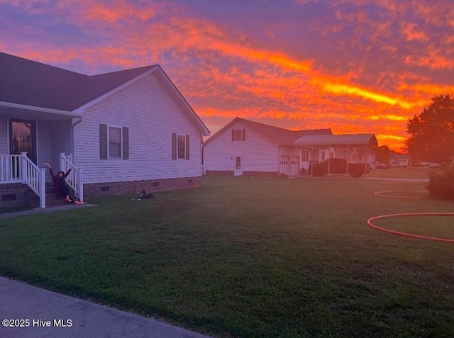 property exterior at dusk with a lawn