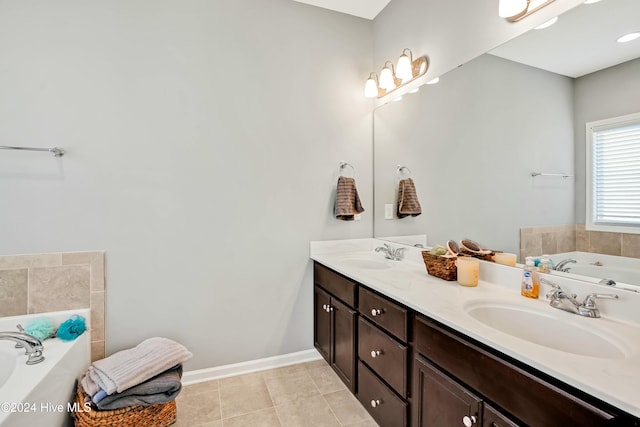 bathroom featuring a tub to relax in, tile patterned floors, and vanity