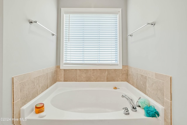 bathroom featuring a tub and a wealth of natural light