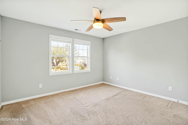 carpeted empty room with ceiling fan