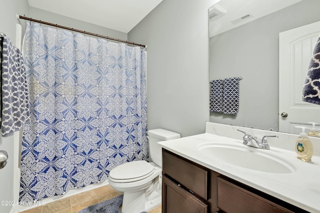 bathroom featuring tile patterned floors, vanity, and toilet