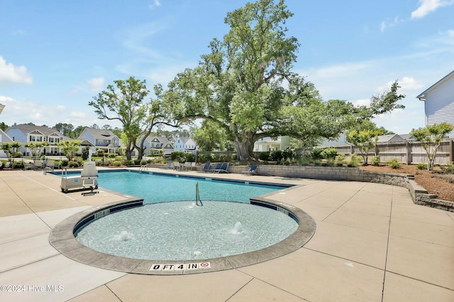 view of swimming pool featuring a patio area and pool water feature