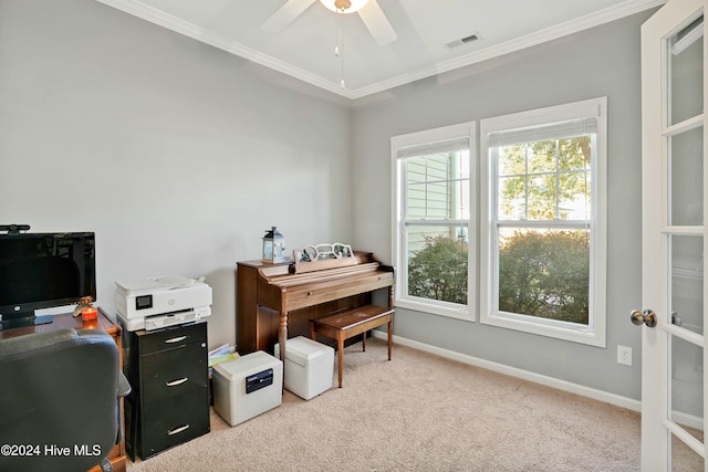 interior space featuring ceiling fan, light colored carpet, and ornamental molding