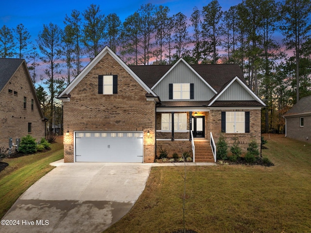 craftsman-style home featuring a garage and a lawn