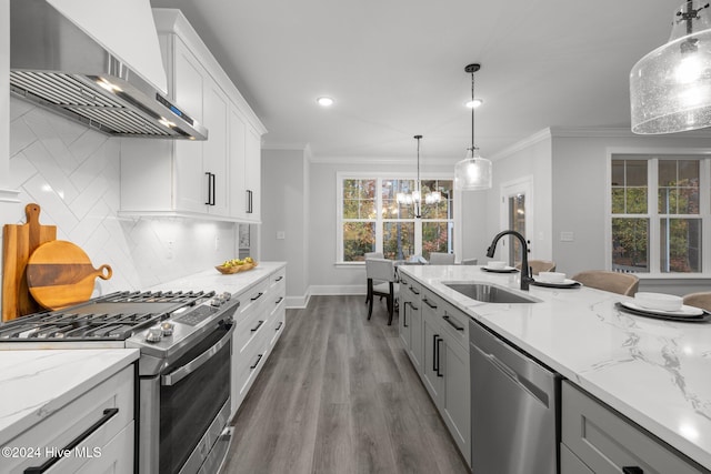 kitchen with decorative backsplash, wall chimney exhaust hood, stainless steel appliances, sink, and light hardwood / wood-style floors