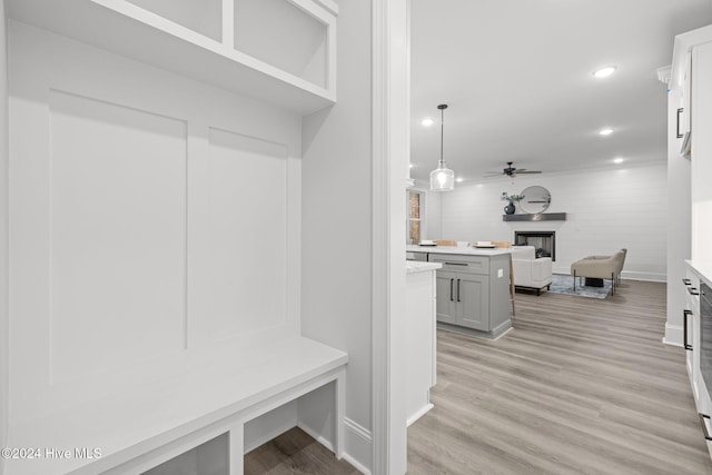 mudroom with ceiling fan and light hardwood / wood-style flooring