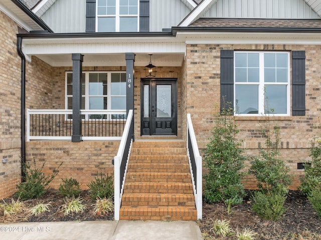 entrance to property featuring a porch