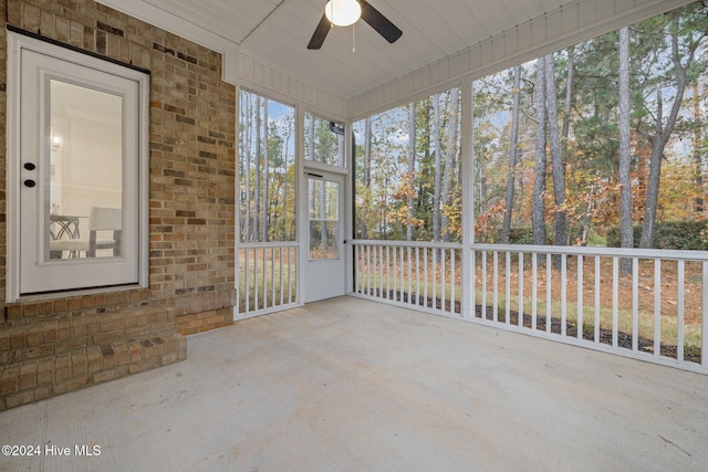 unfurnished sunroom featuring ceiling fan