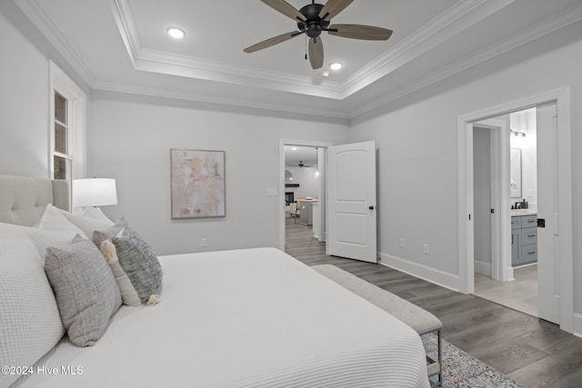 bedroom featuring ensuite bath, crown molding, light hardwood / wood-style flooring, and ceiling fan