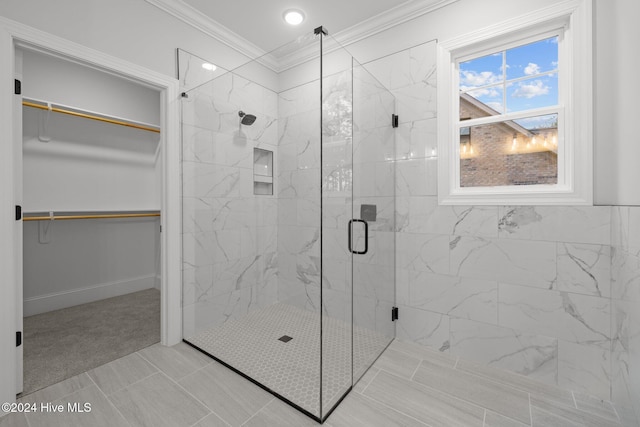 bathroom featuring tile patterned floors, an enclosed shower, and crown molding