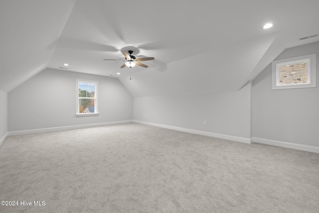 additional living space with carpet flooring, ceiling fan, and lofted ceiling