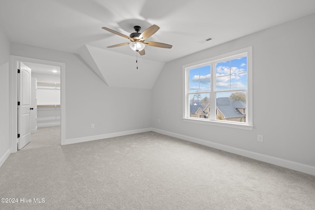 bonus room with ceiling fan, light carpet, and vaulted ceiling