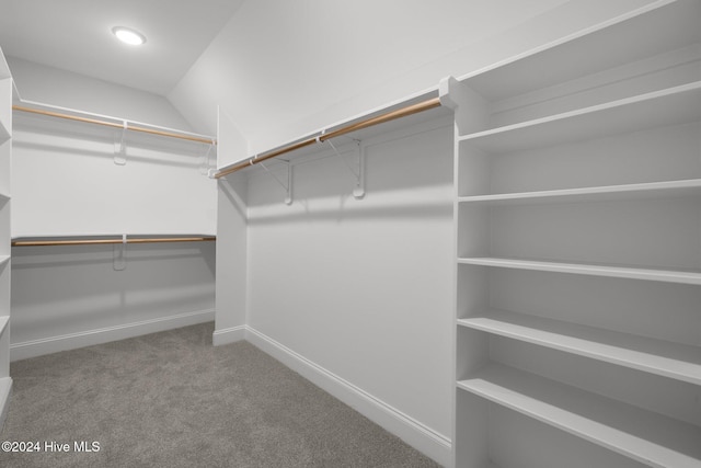 walk in closet with carpet floors and vaulted ceiling