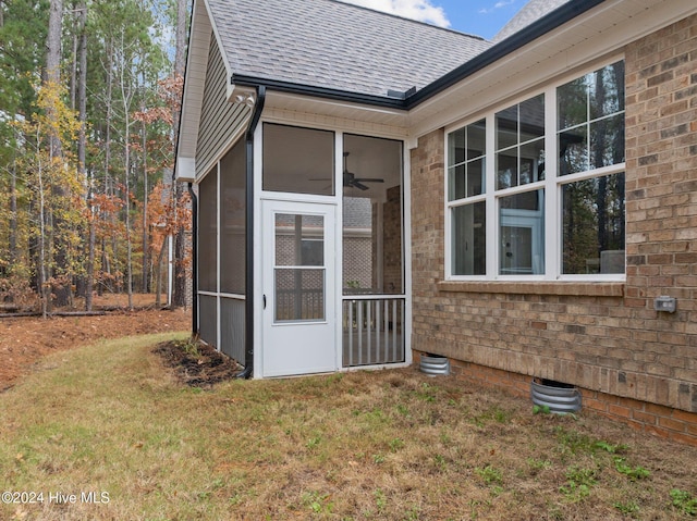 exterior space featuring a sunroom and a yard