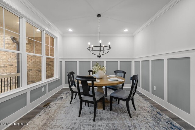 dining space with a chandelier, dark hardwood / wood-style flooring, and crown molding