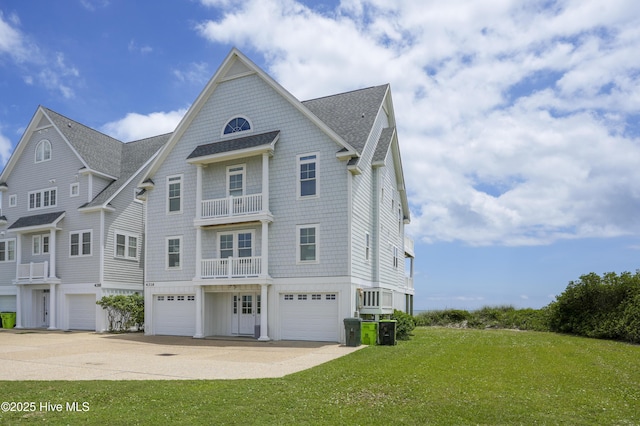 4316 Island Dr, North Topsail Beach, NC 28460 - view of front of home with concrete driveway, roof with shingles, an attached garage, and a front lawn