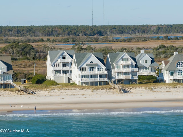 drone / aerial view featuring a water view and a beach view