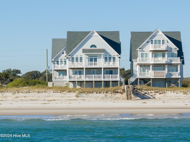 4316 Island Dr, North Topsail Beach, NC 28460 - rear view of property featuring view of water and beach, a shingled roof, and a balcony