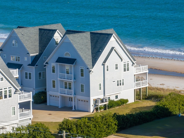 birds eye view of property featuring a beach view and a water view