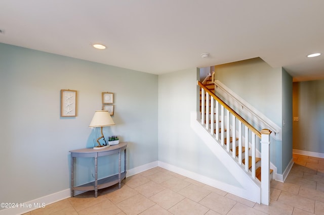 stairs featuring tile patterned flooring