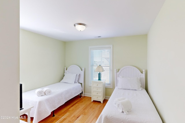 bedroom with wood-type flooring