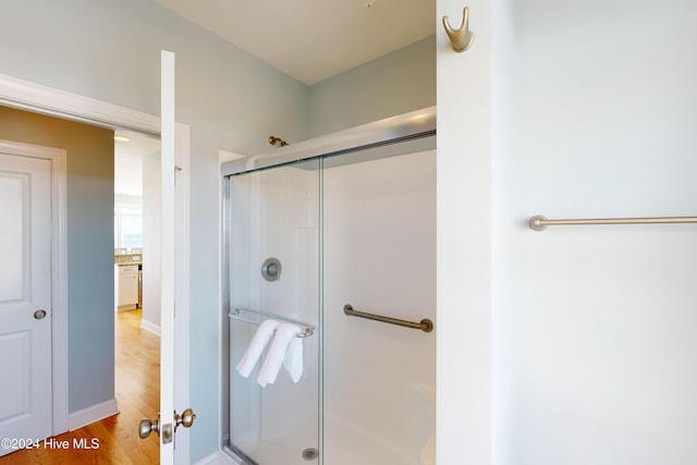 4316 Island Dr, North Topsail Beach, NC 28460 - bathroom featuring a stall shower and wood finished floors