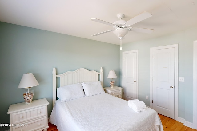 bedroom with ceiling fan and light hardwood / wood-style flooring