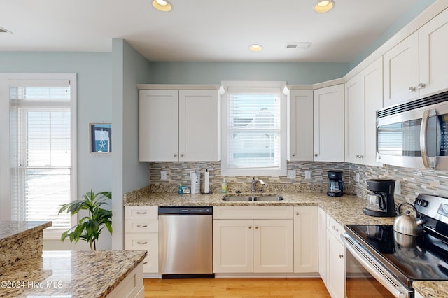4316 Island Dr, North Topsail Beach, NC 28460 - kitchen with stainless steel appliances, a sink, backsplash, plenty of natural light, and recessed lighting