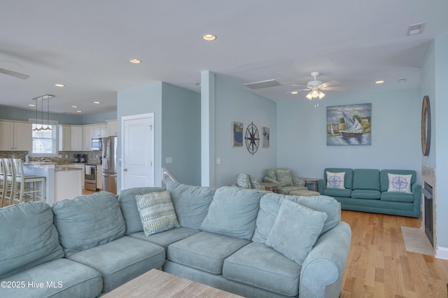 4316 Island Dr, North Topsail Beach, NC 28460 - living room featuring ceiling fan, light wood-type flooring, and recessed lighting