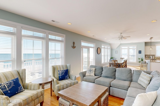 living room featuring ceiling fan and light wood-type flooring