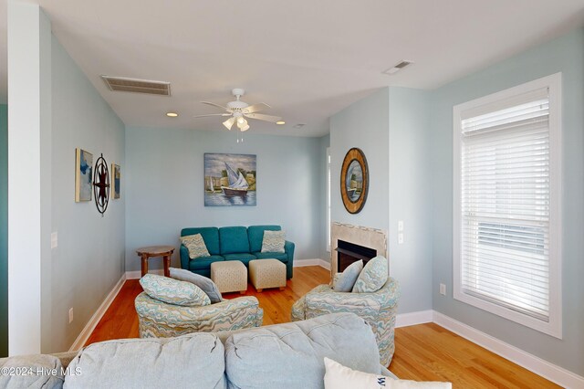 living room featuring hardwood / wood-style floors and ceiling fan