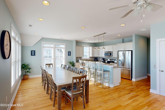 dining room featuring ceiling fan and light hardwood / wood-style floors