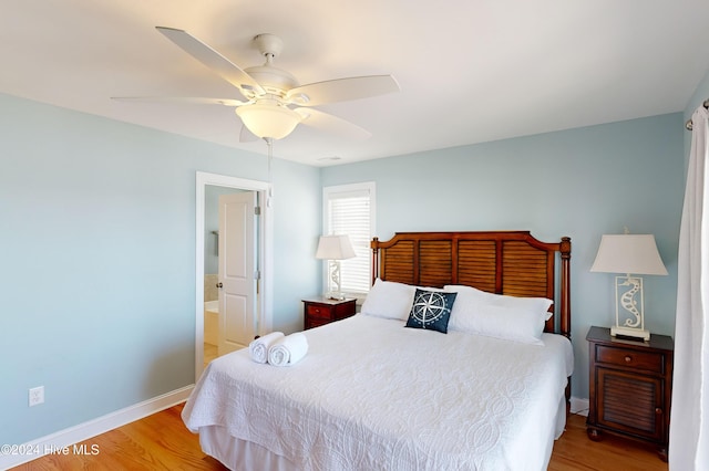 4316 Island Dr, North Topsail Beach, NC 28460 - bedroom with light wood-style floors, baseboards, connected bathroom, and ceiling fan