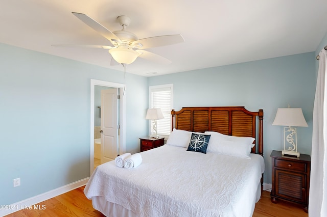 bedroom featuring ensuite bathroom, ceiling fan, and light hardwood / wood-style floors