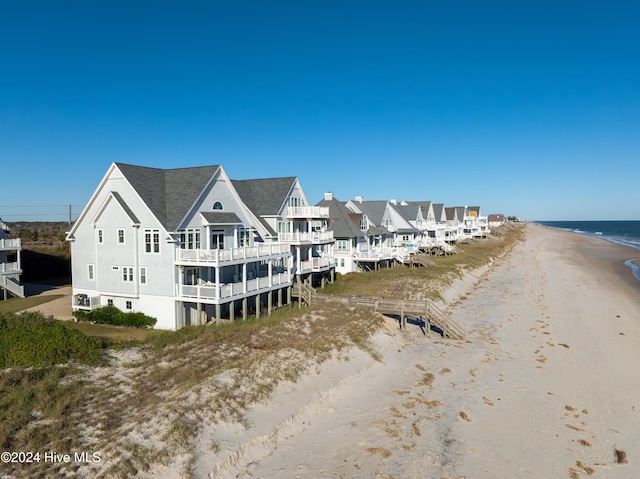 aerial view featuring a water view and a beach view