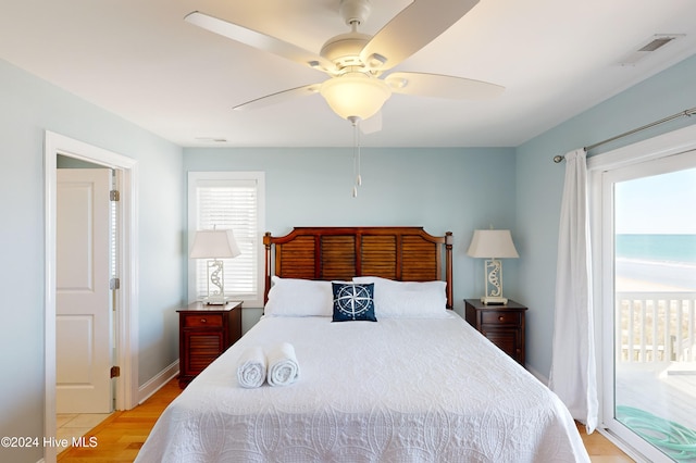 bedroom with access to outside, ceiling fan, and light wood-type flooring