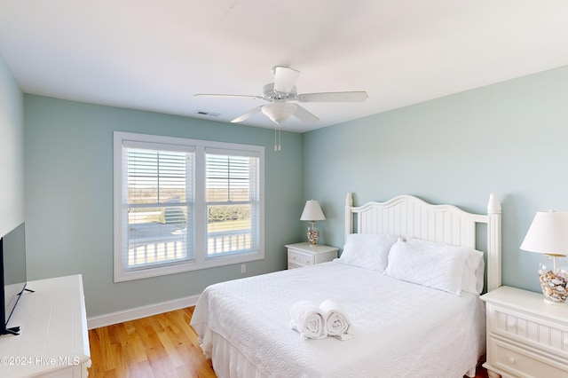 bedroom with light hardwood / wood-style floors and ceiling fan