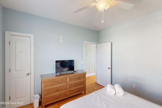 bedroom with hardwood / wood-style floors and ceiling fan